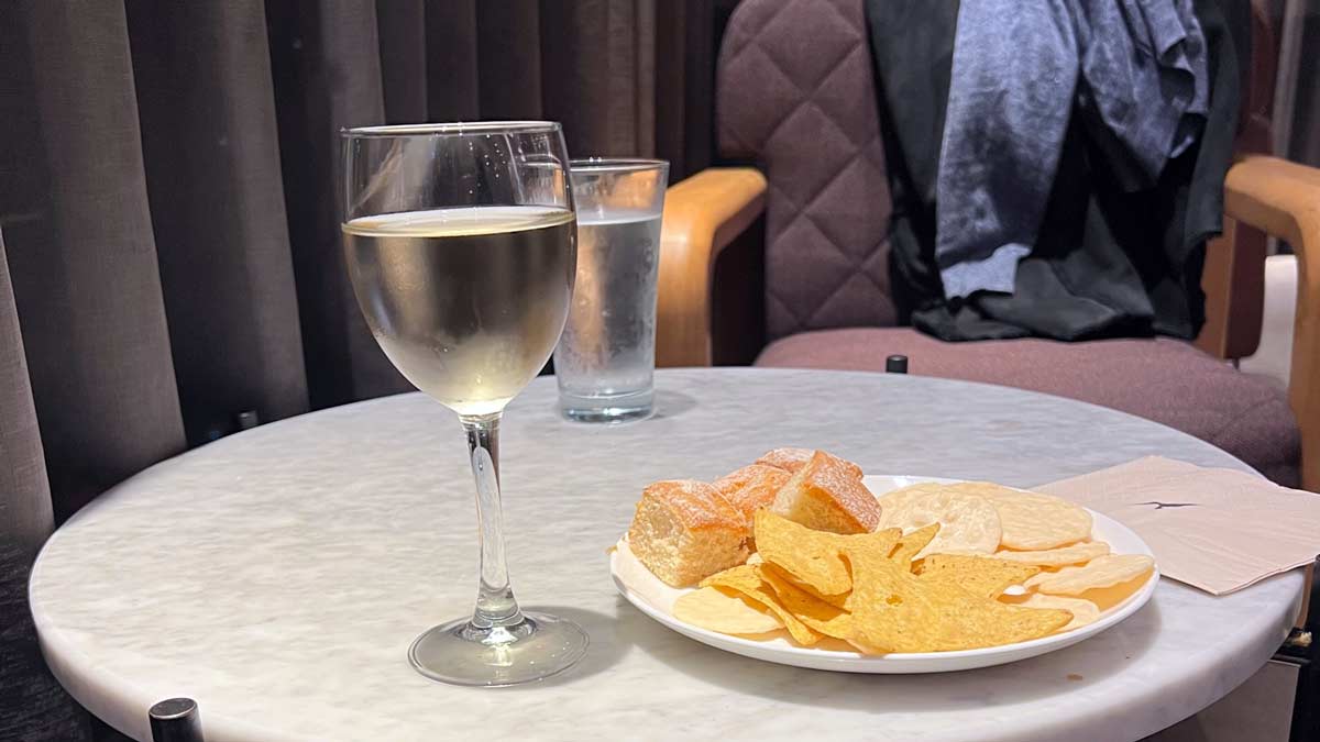 a plate of food and a glass of wine on a table