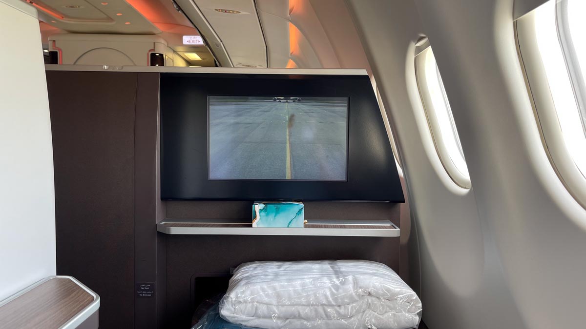 a tv on a shelf in an airplane