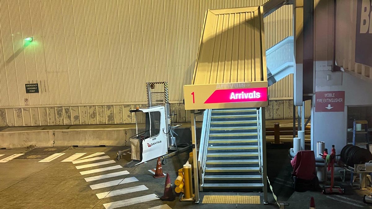 a staircase with a sign and a truck in front of it