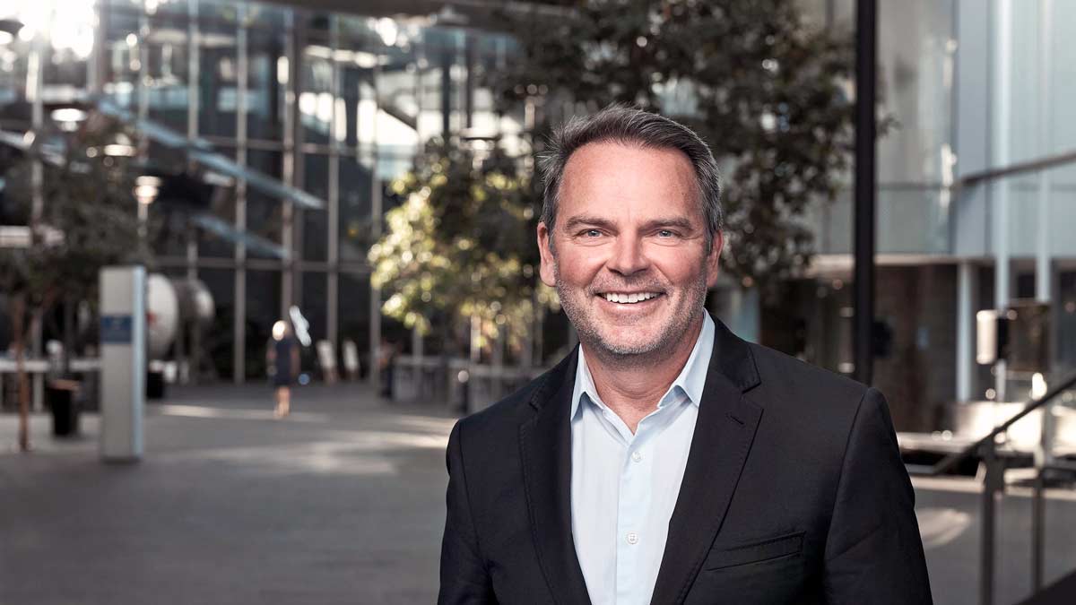 a man in a suit smiling