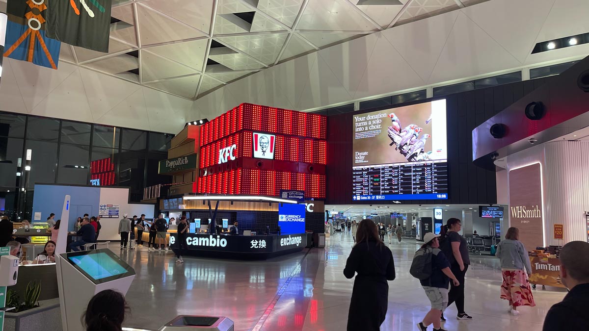 a group of people in a large airport terminal