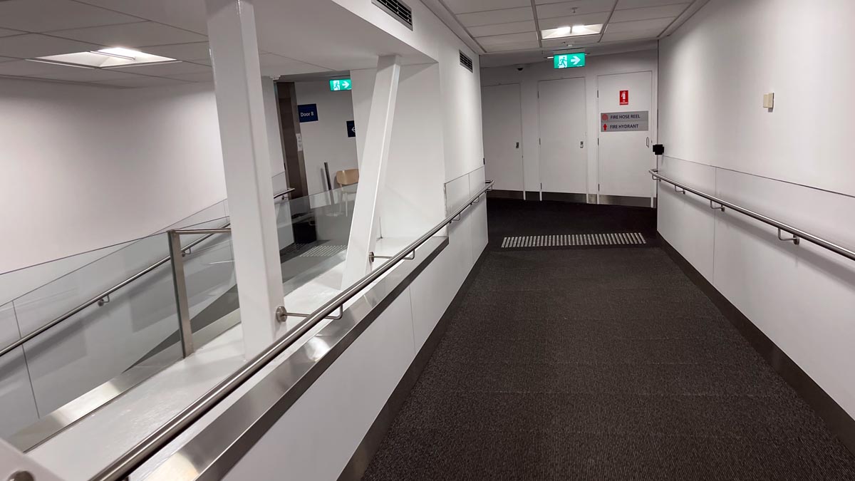 a hallway with a metal railing