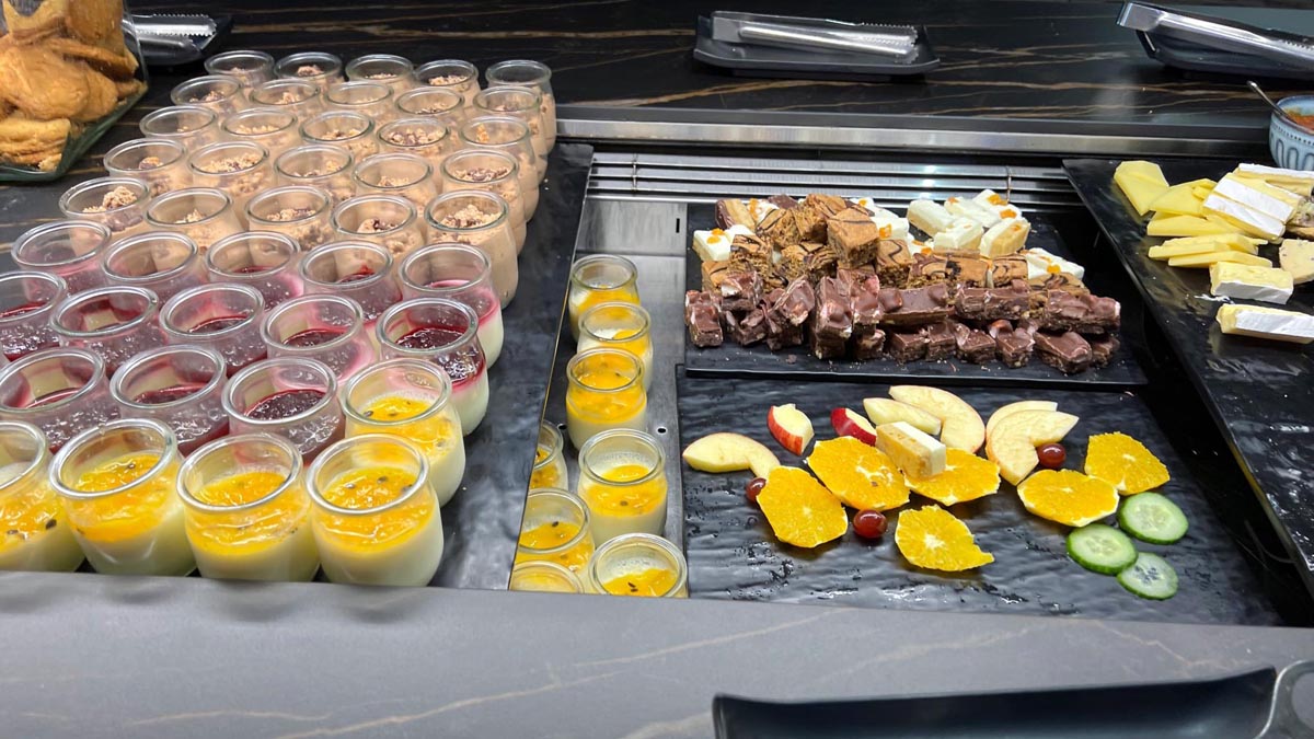 a buffet table with desserts and fruit