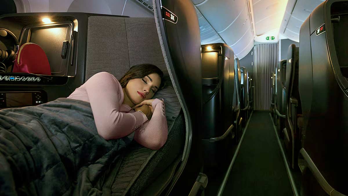 a woman sleeping on an airplane