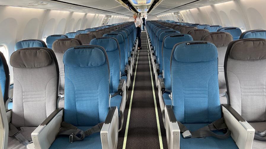 a row of blue seats on an airplane