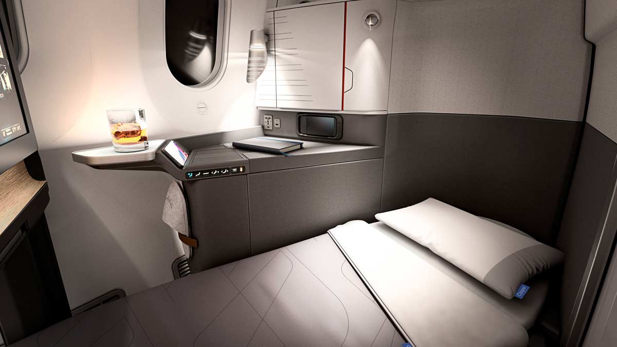 a bed and a glass of drink on a table in a plane