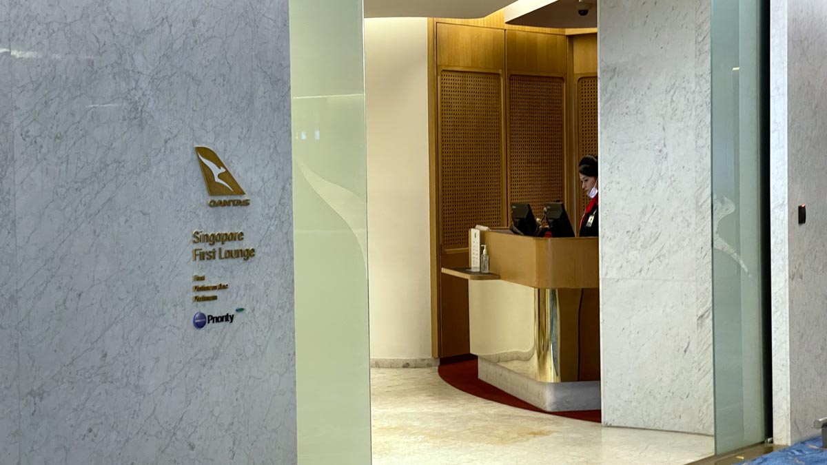 a woman standing at a desk in a lobby