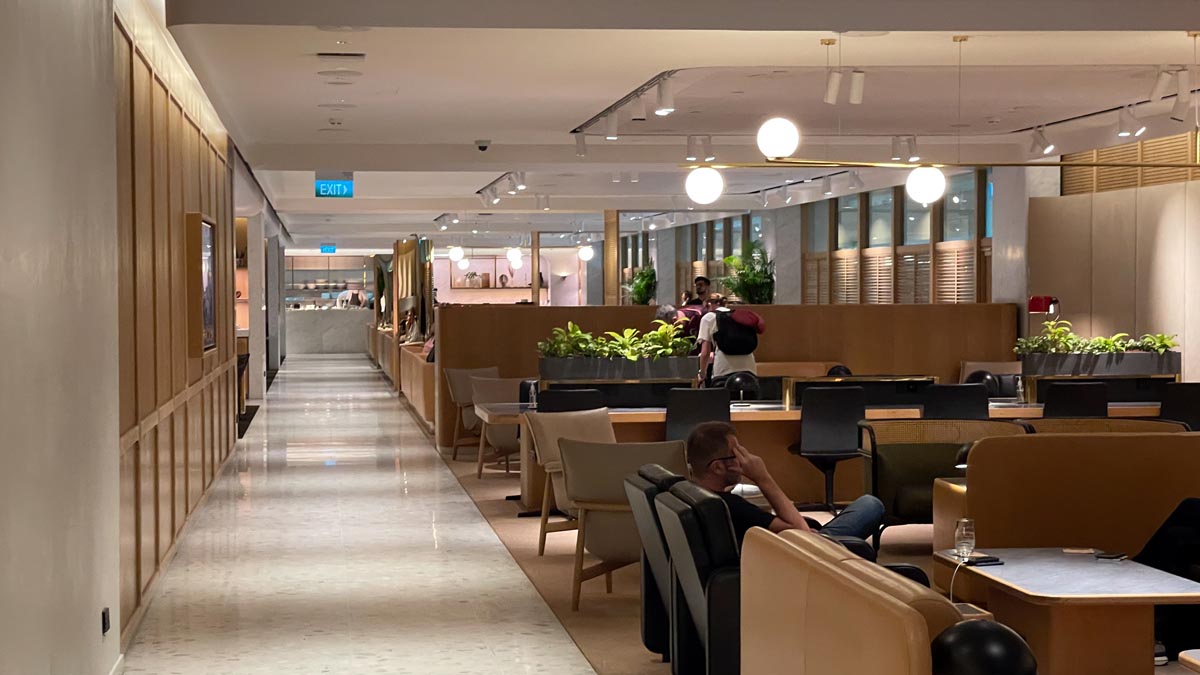 a room with chairs and tables and people in it