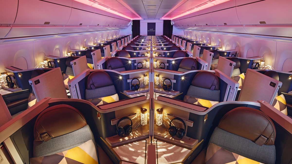 a room with rows of seats and a pink light