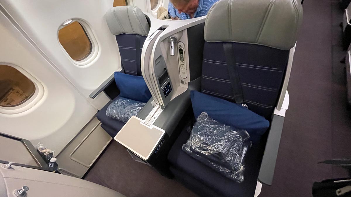 a man looking at a seat in an airplane