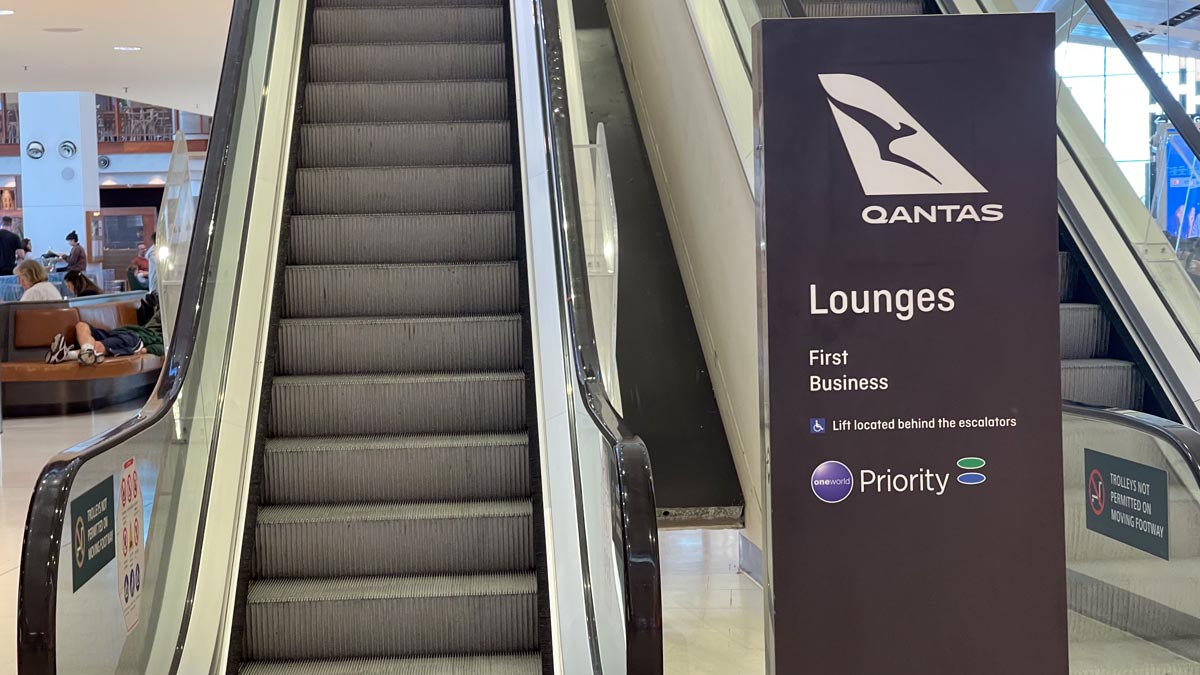 an escalator and an escalator sign