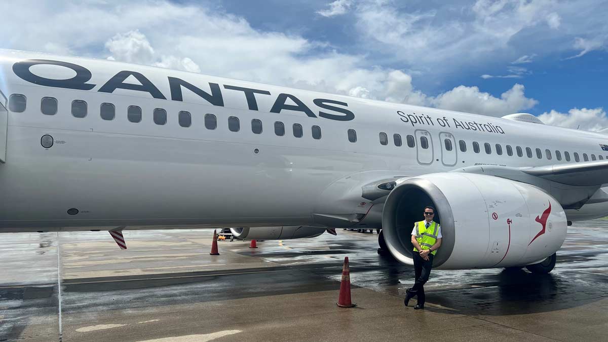 a man standing in front of an airplane