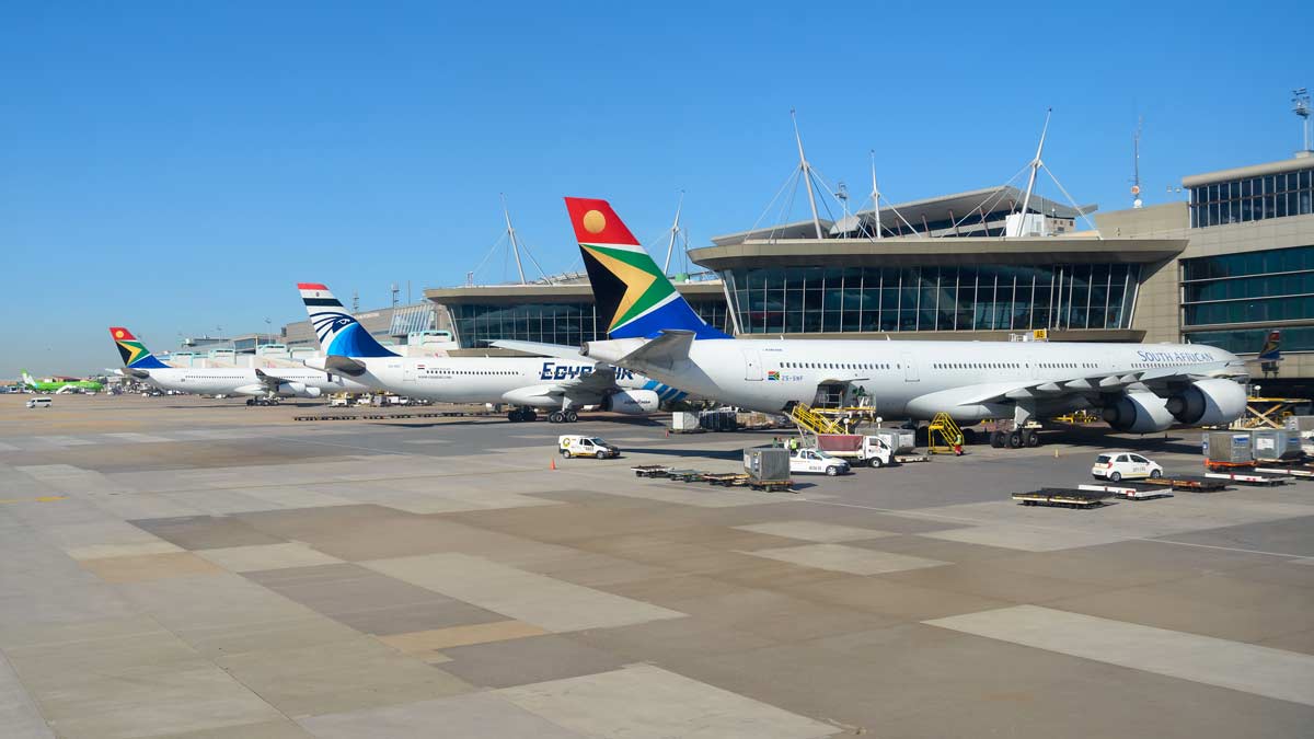 a group of airplanes at an airport