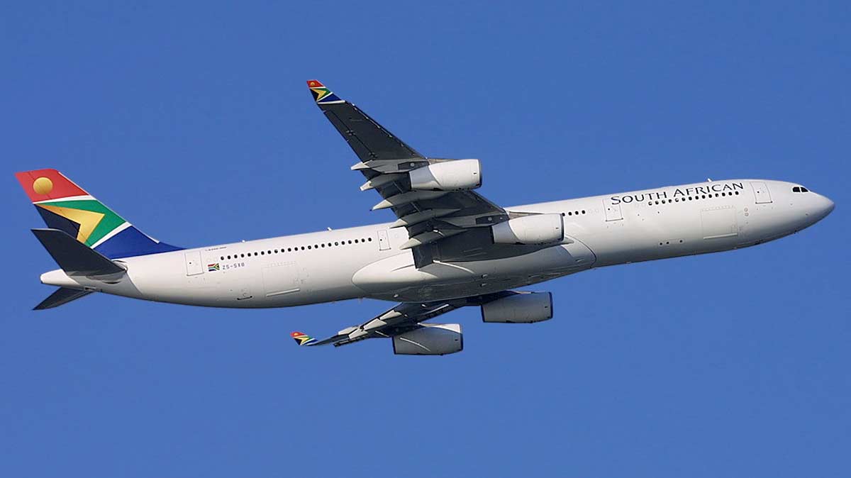 a large white airplane flying in the sky