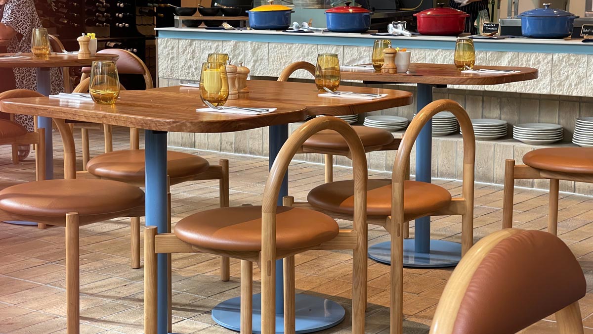 a table with chairs and utensils in a restaurant