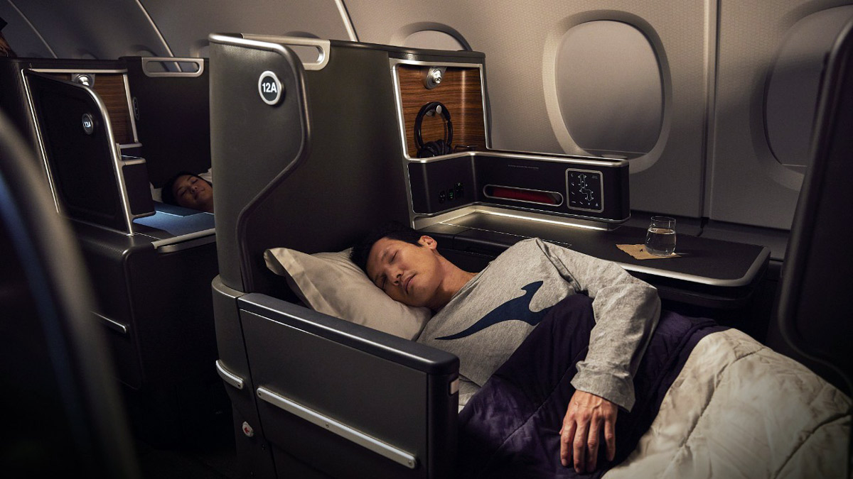 a man sleeping in a plane