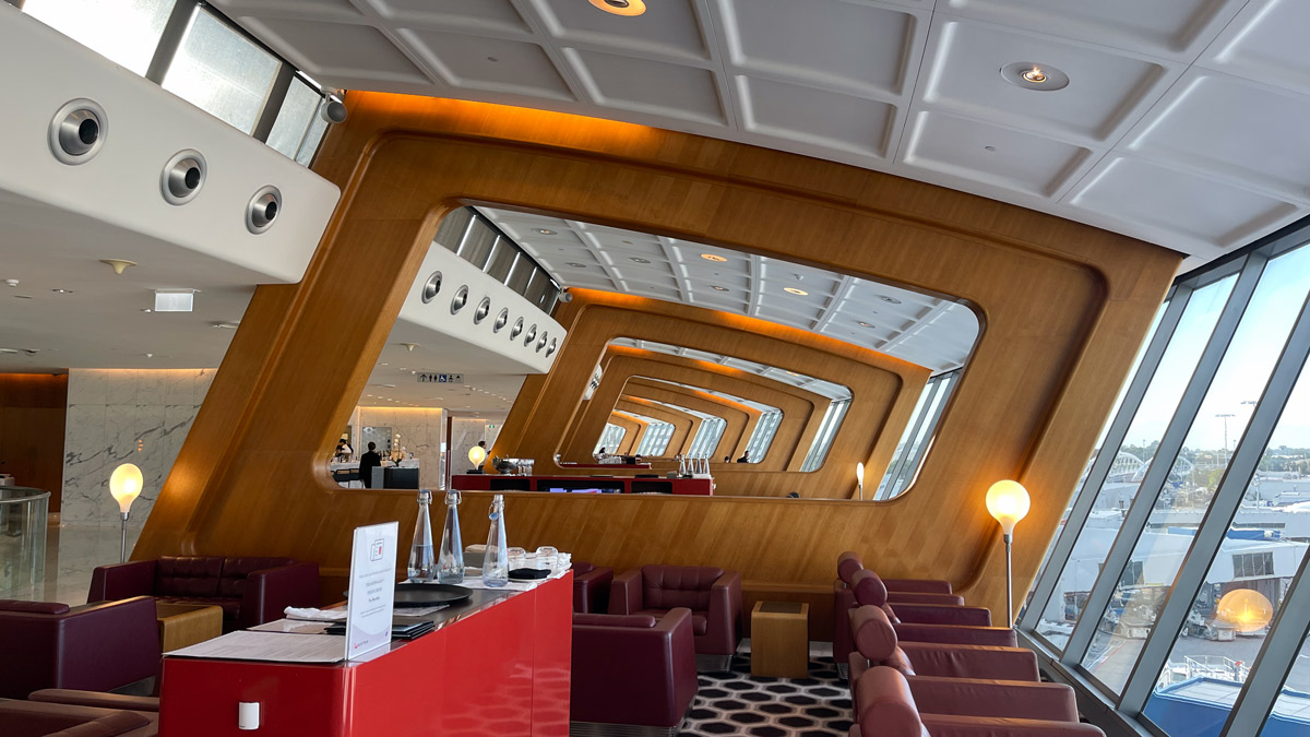 a room with a red counter and chairs