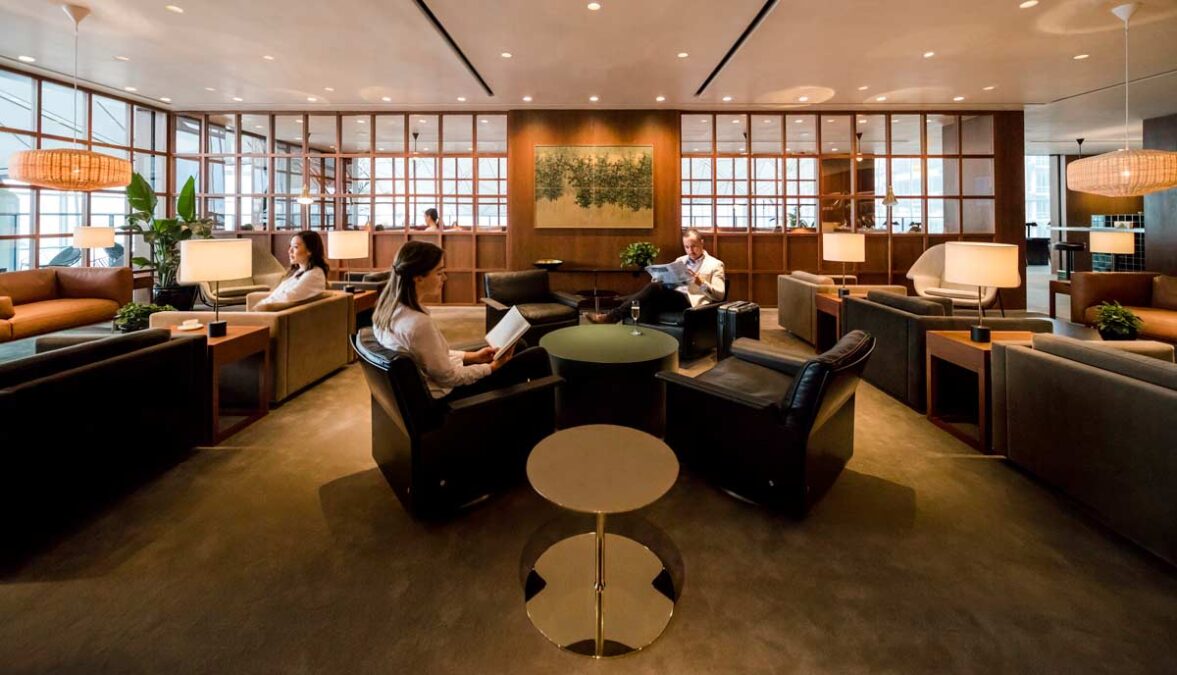 people sitting in a room with a table and chairs