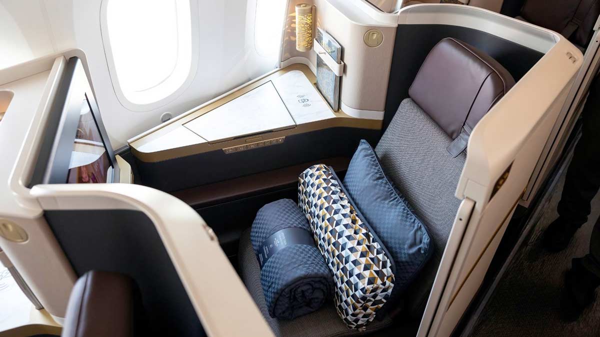 a seat with pillows and a pillow on the back