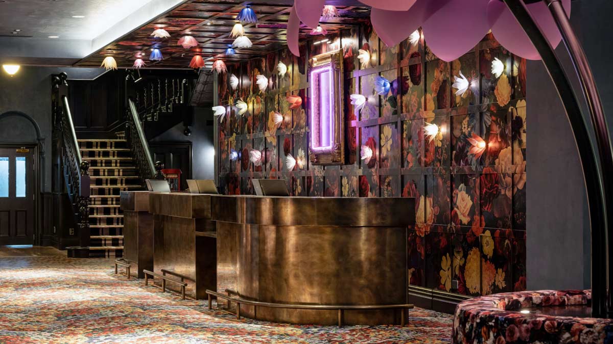a reception desk in a room with colorful lights