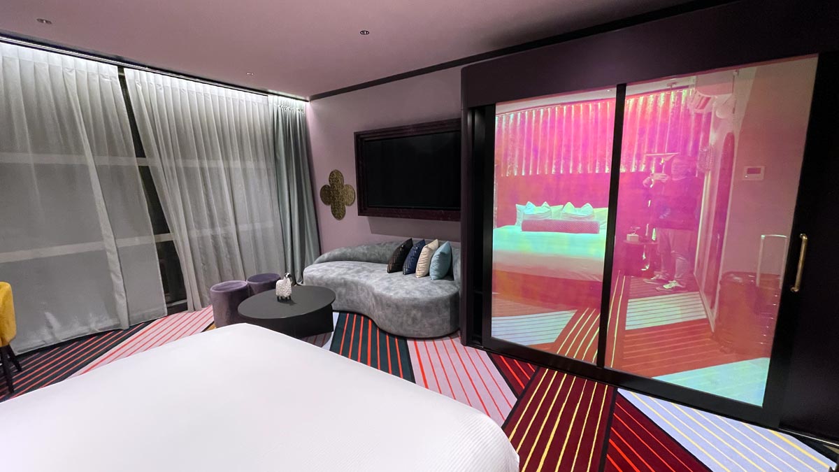 a room with a bed and a television
