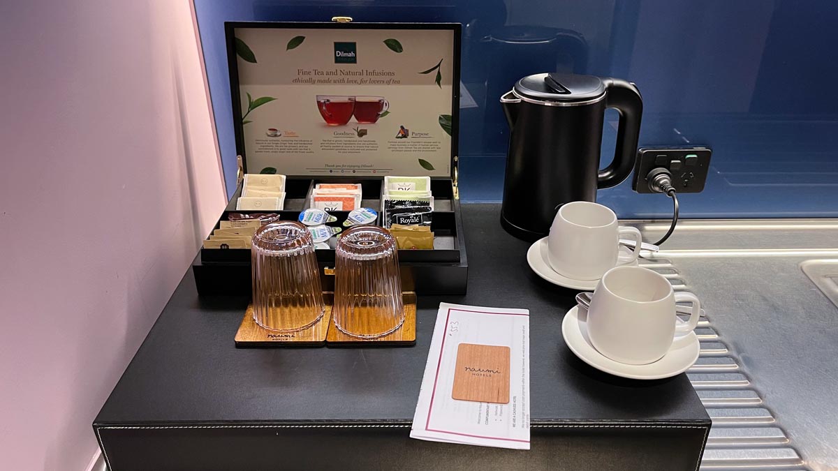 a tray with cups and teapots on a table