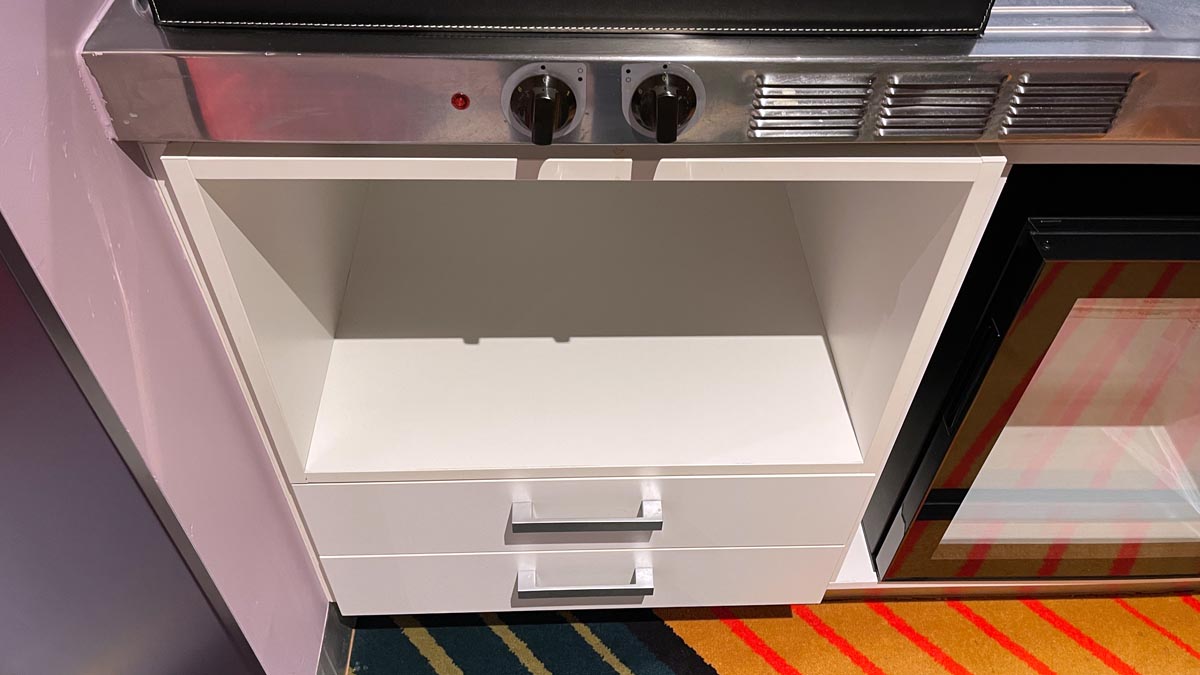 a white drawer with knobs and a shelf