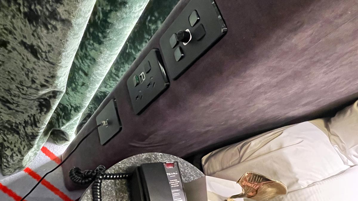 a wall outlet and a telephone on a bed