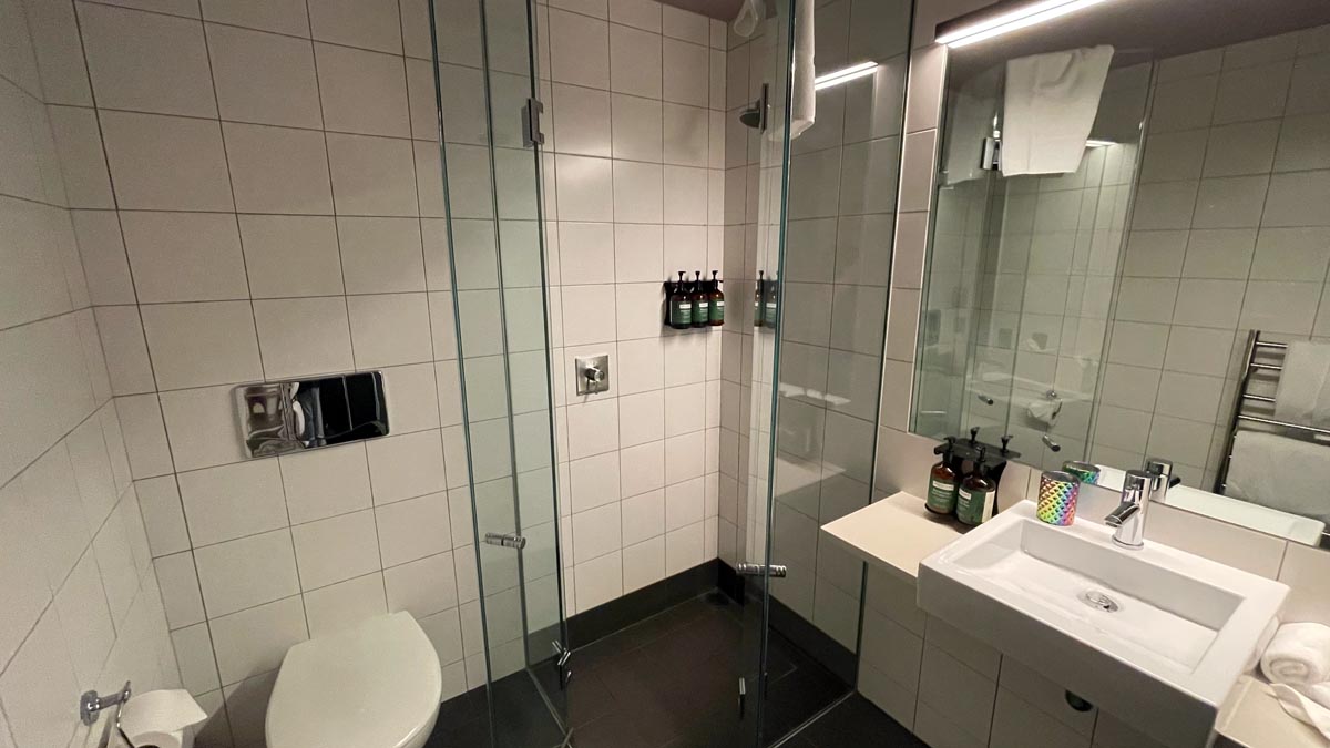a bathroom with a glass shower door
