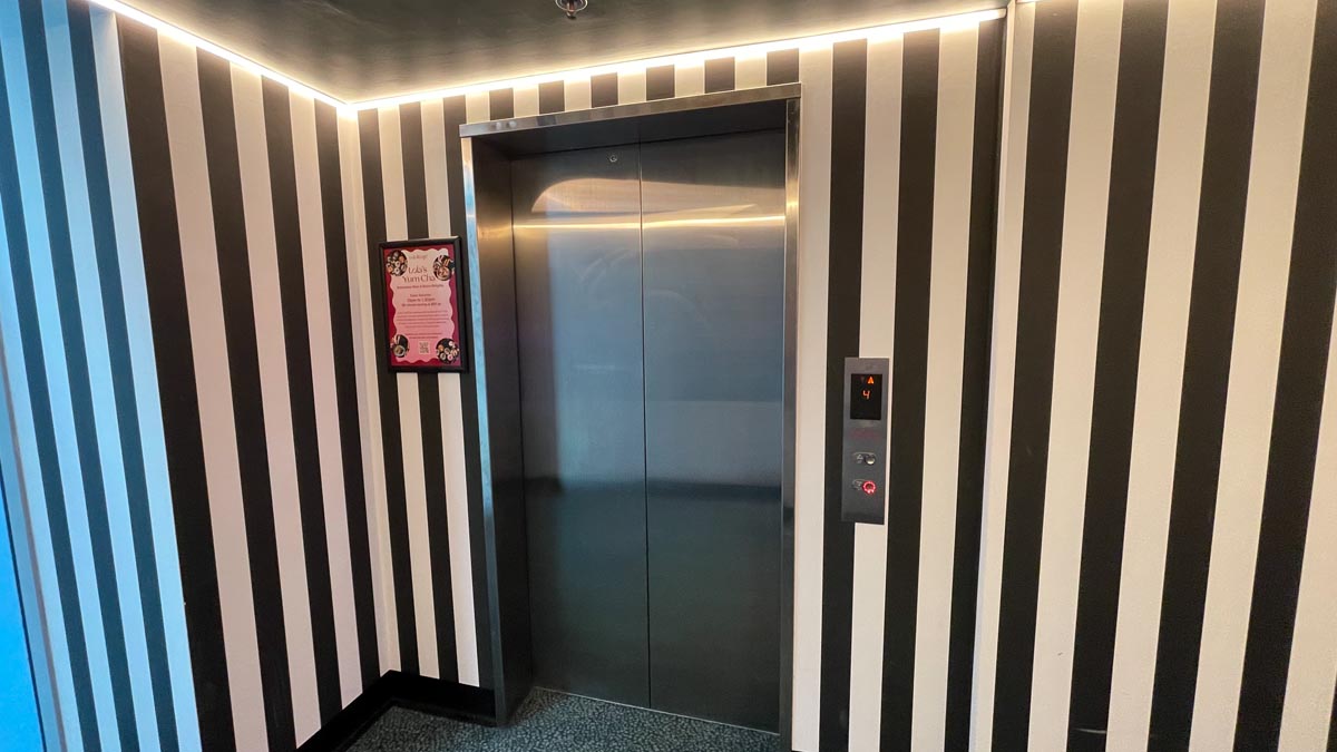 an elevator with a black and white striped wall