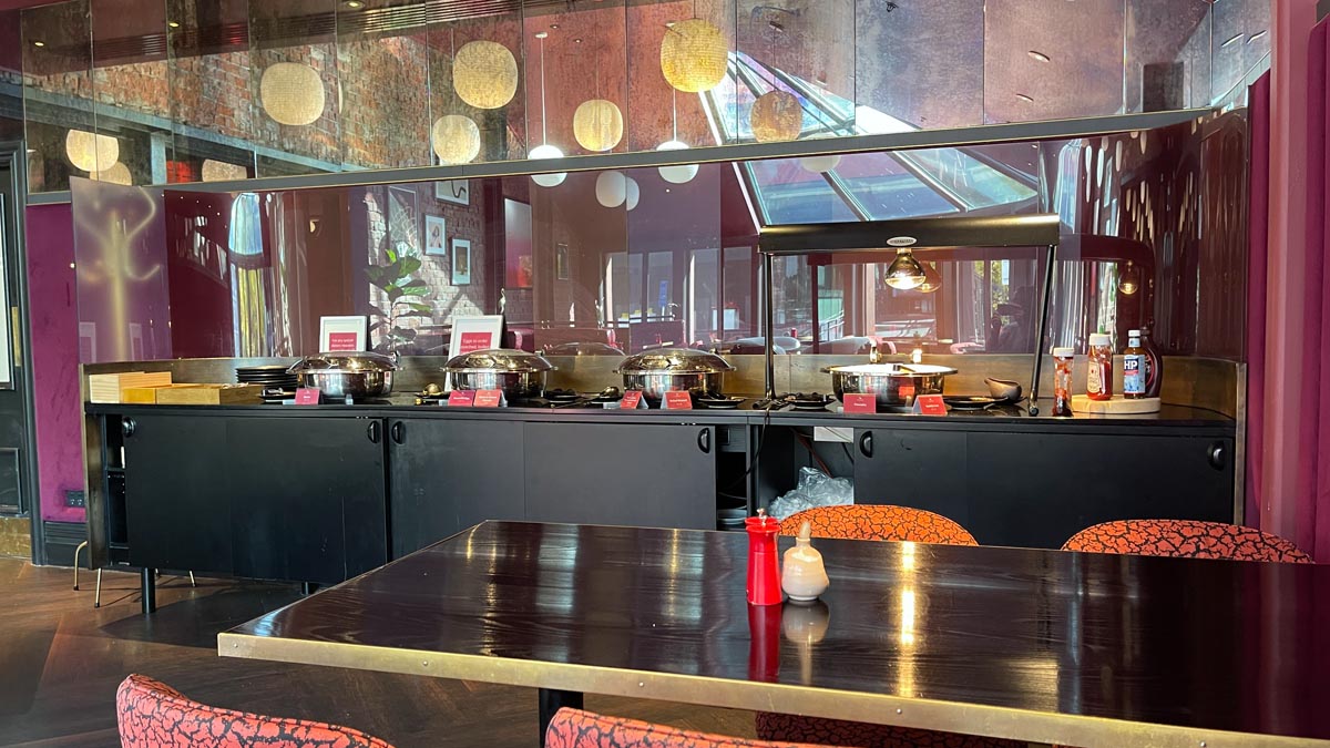a restaurant with a row of food