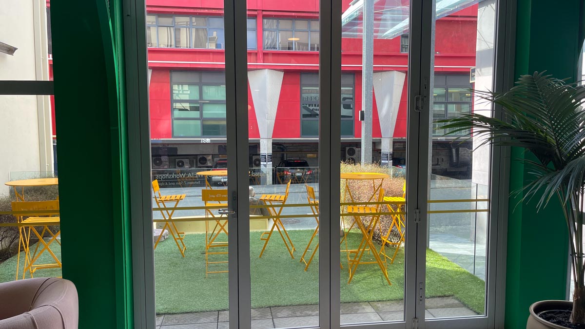 a glass door with a table and chairs outside