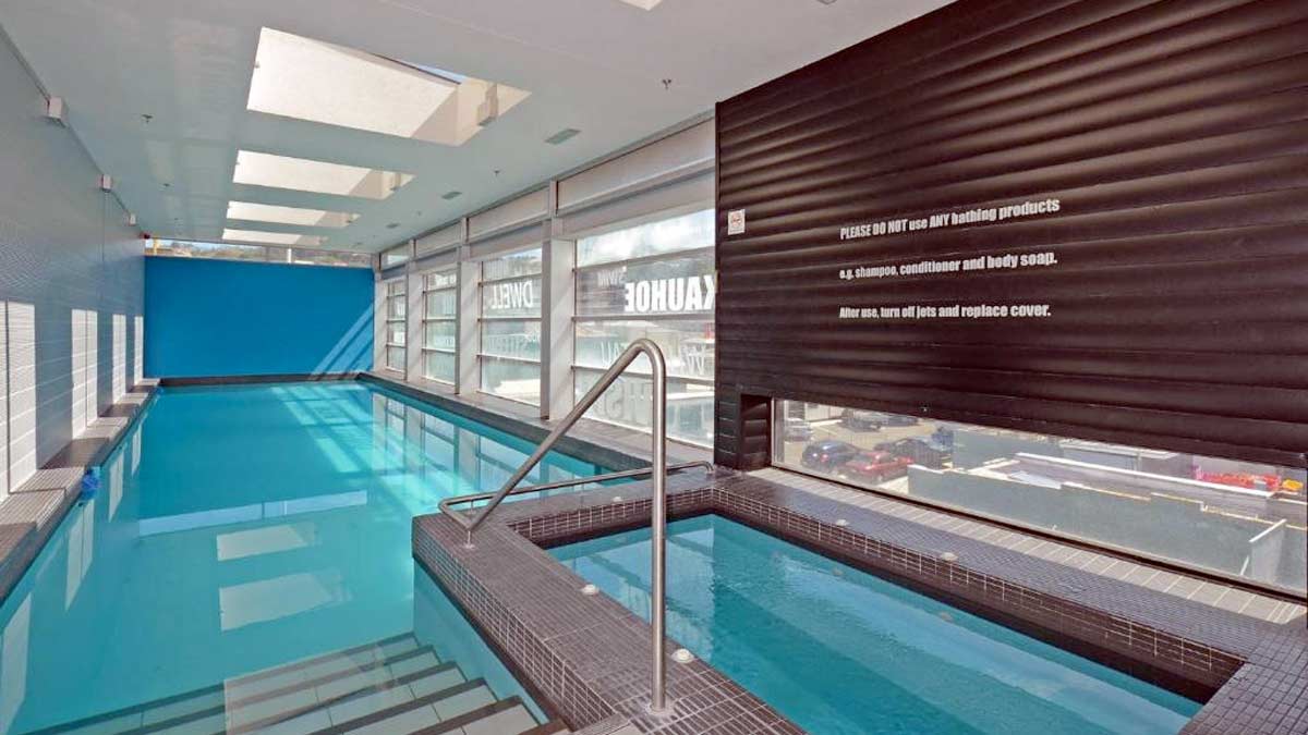 a swimming pool with a railing