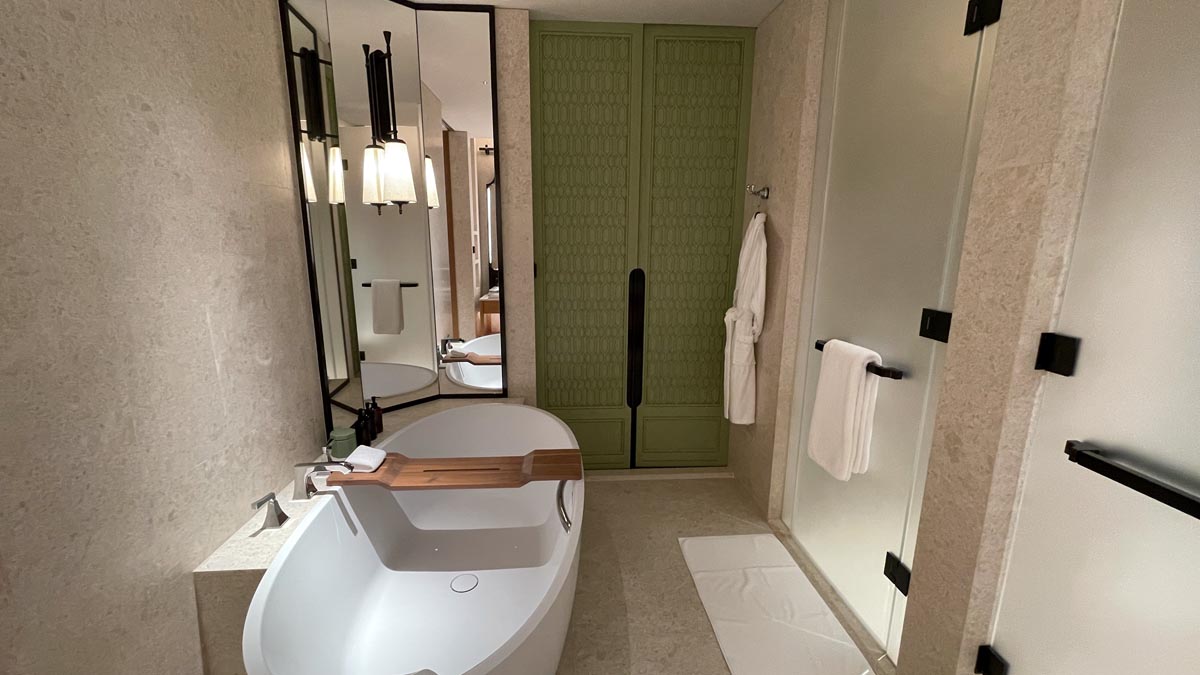 a bathroom with a tub and a mirror