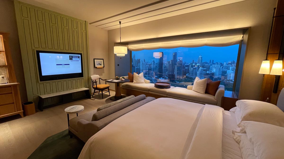 a room with a large window and a large bed