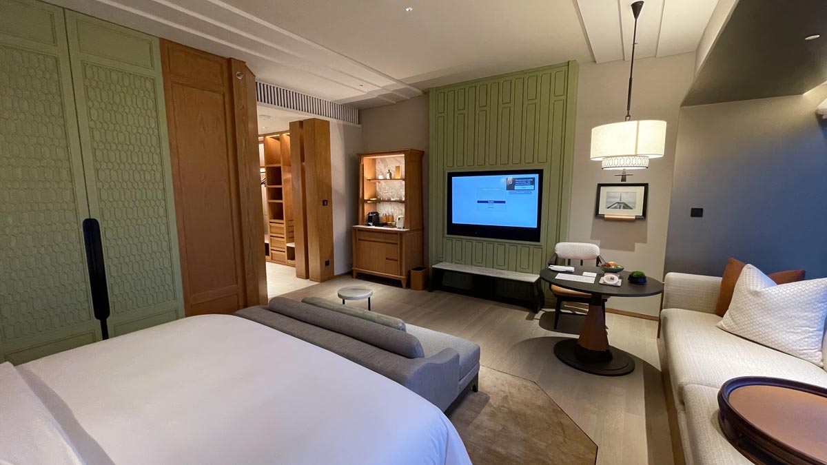 a room with a bed and a television