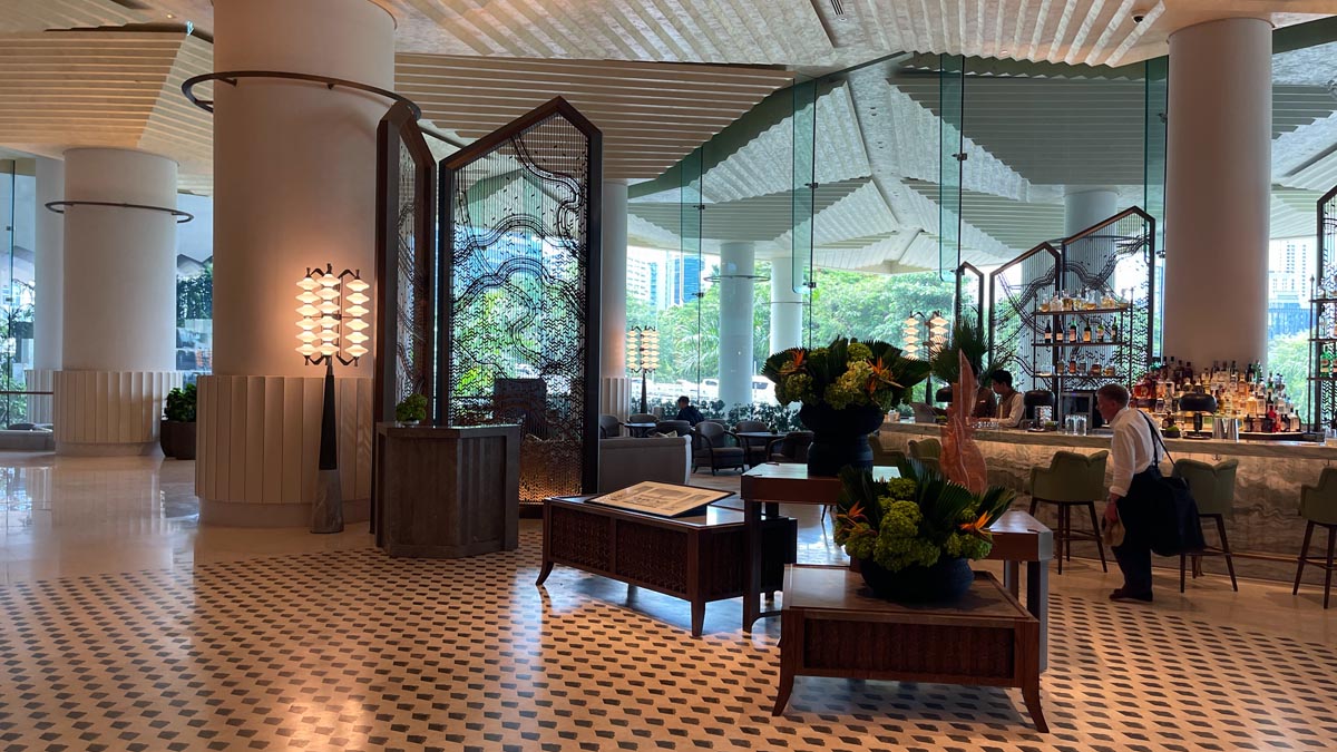 a room with a large glass wall and tables and chairs