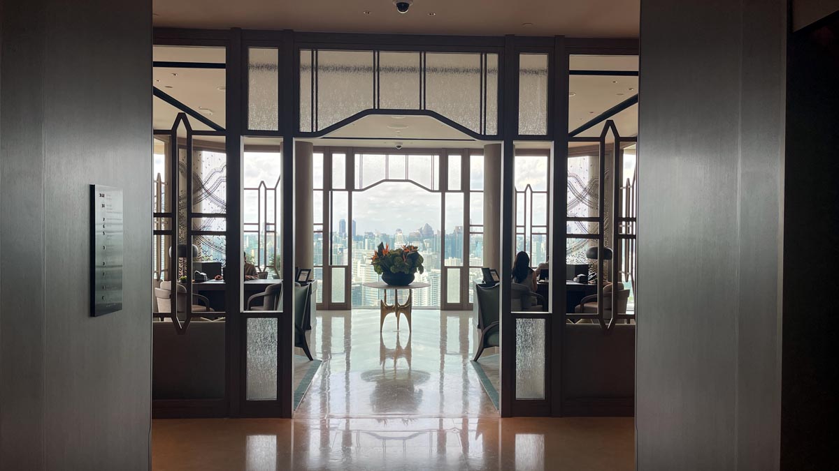 a room with glass doors and a table with flowers