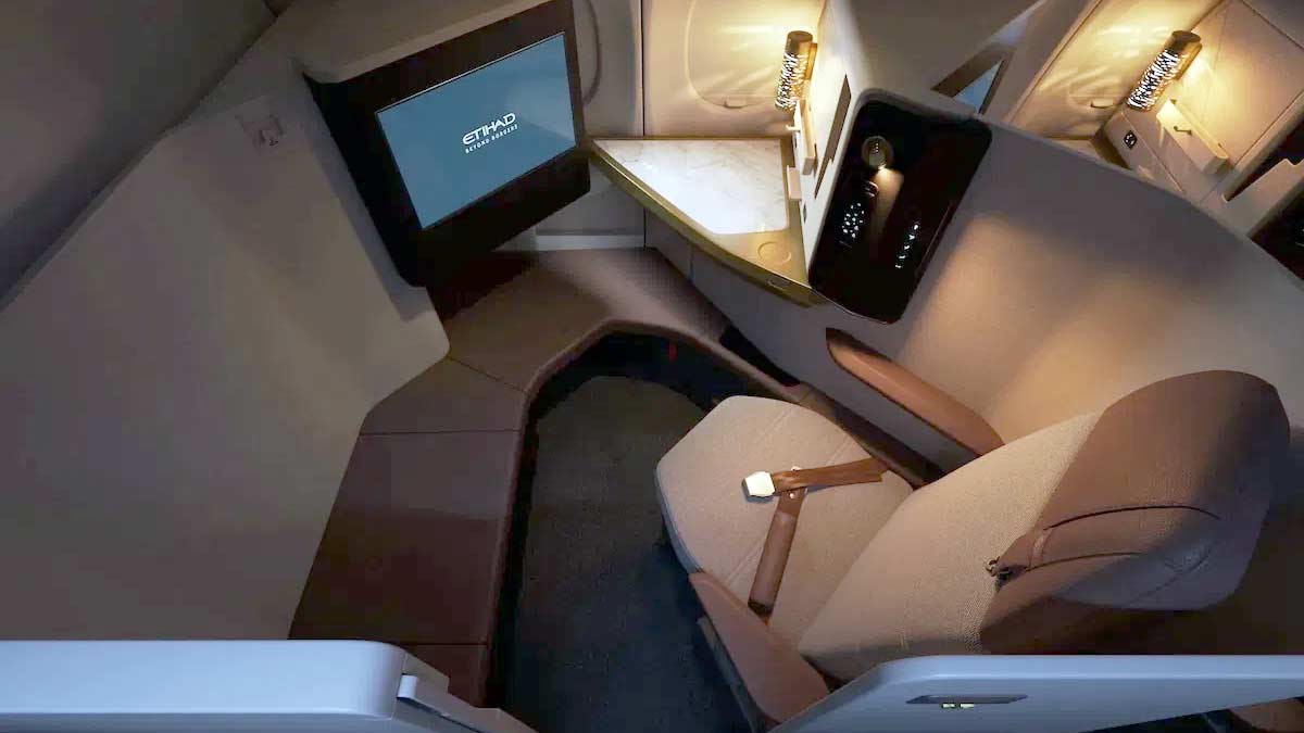 a seat and a tv in a plane