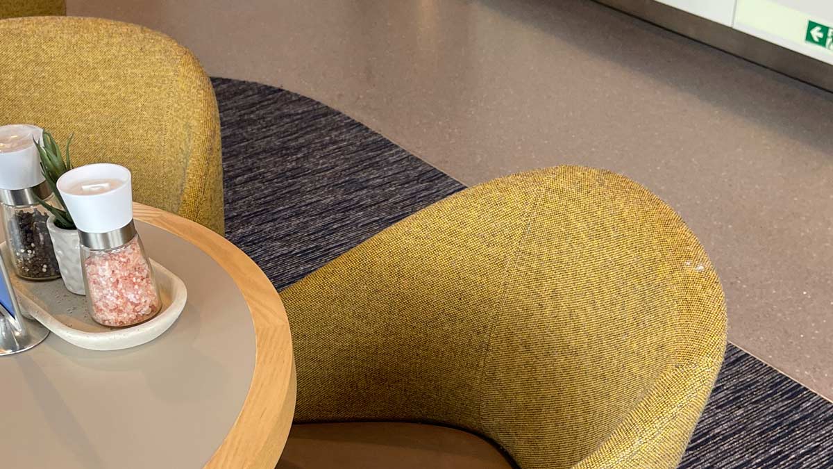 a yellow chair next to a table