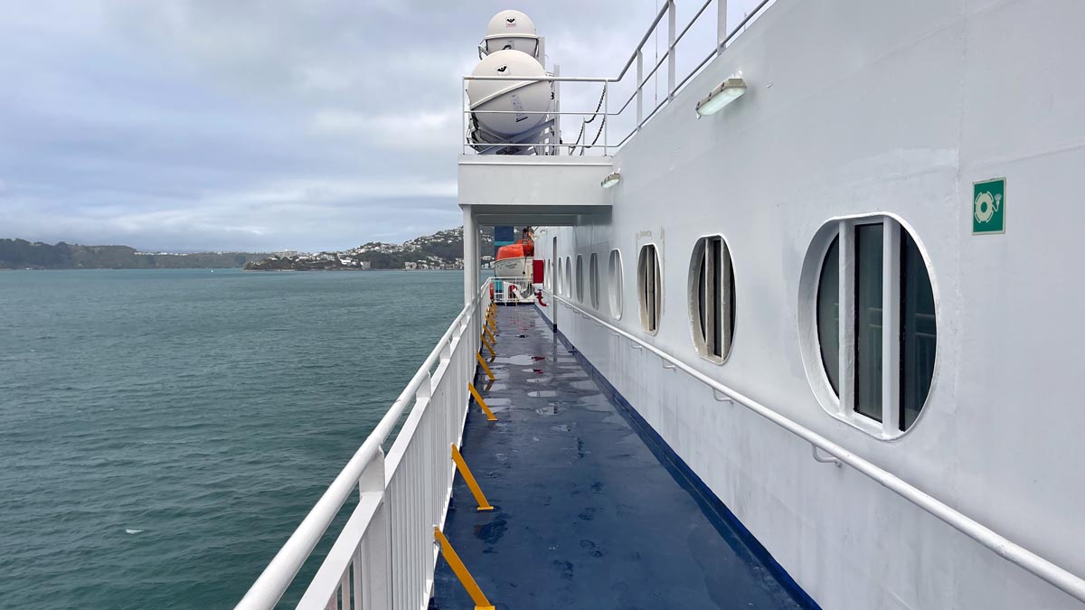 a white boat with round windows and a railing on the side