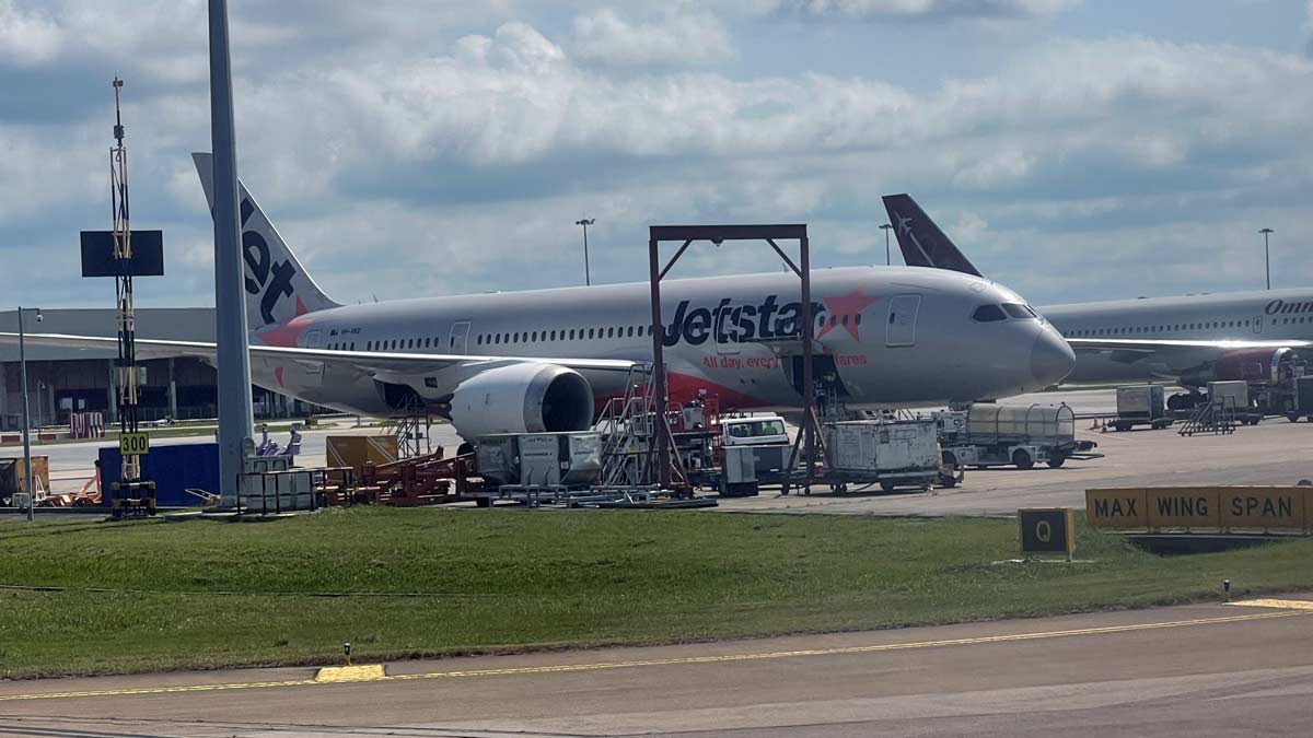 a jet plane parked at an airport with Newark Air Museum in the background