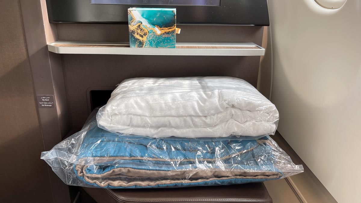 a stack of blankets on a chair