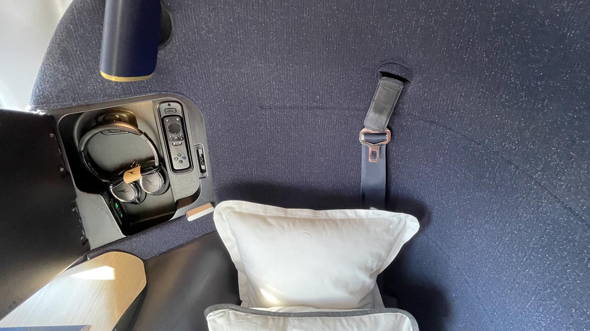 a seat belt and pillow on a seat