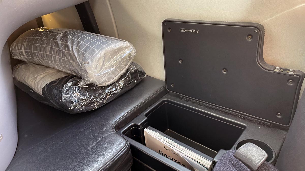 a black seat with a black cover and a black pillow