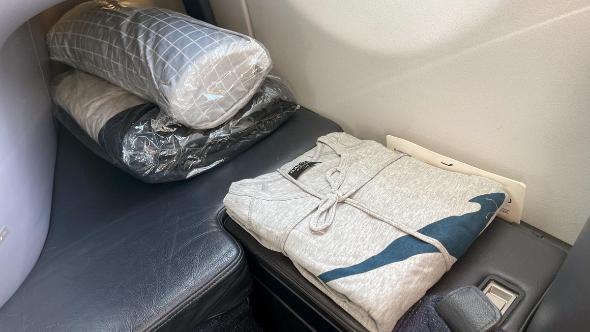 a folded shirt and pillow on a seat