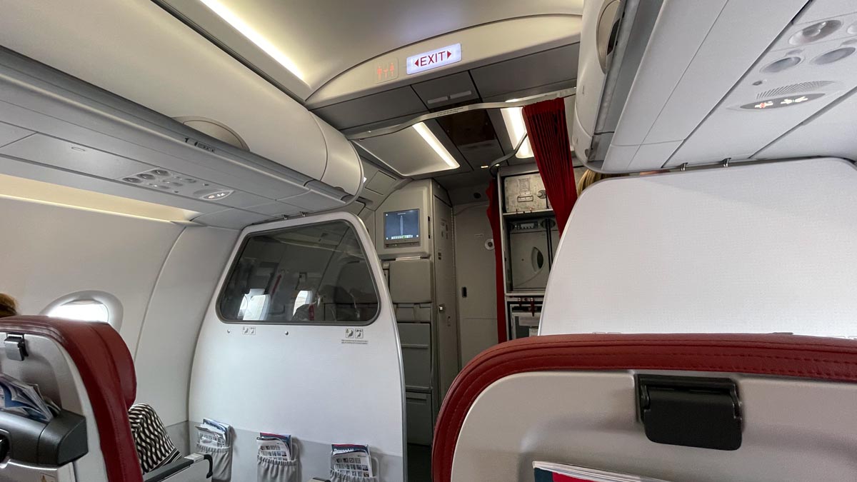 an airplane with a door and a red curtain