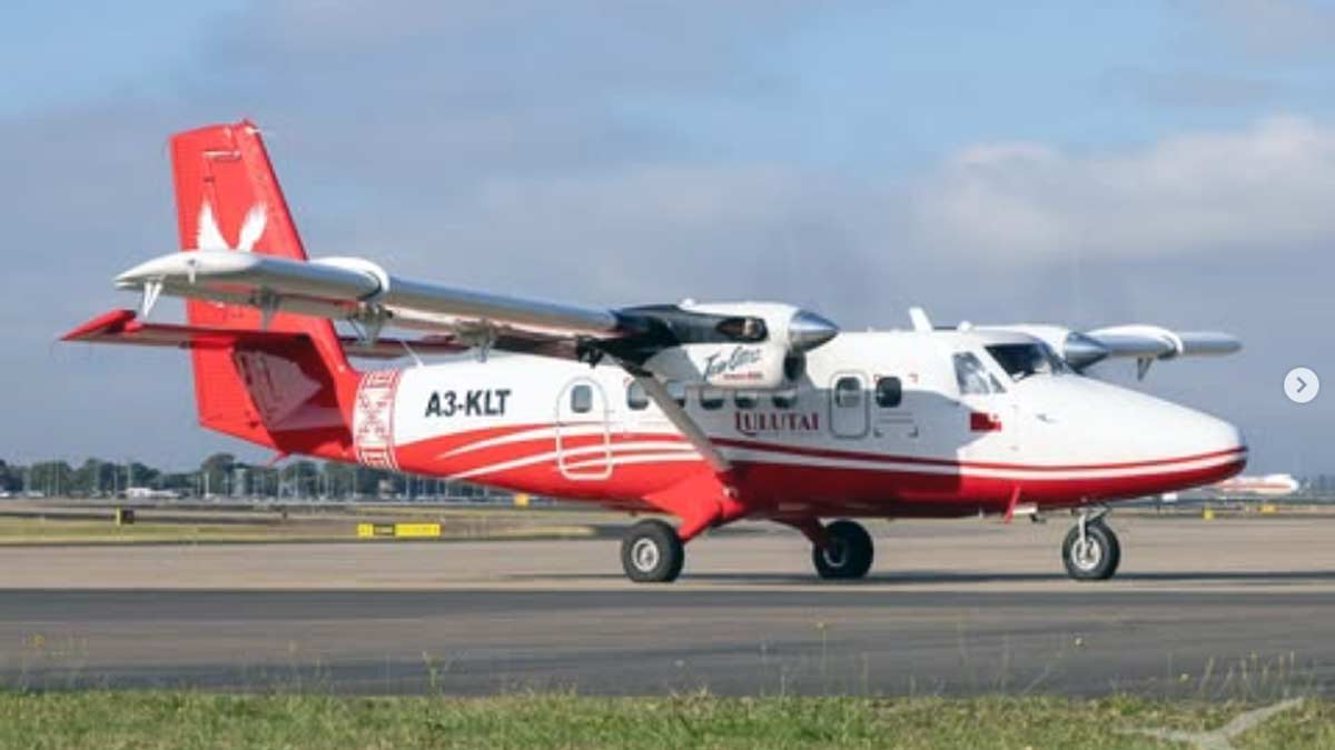 a red and white airplane on a runway