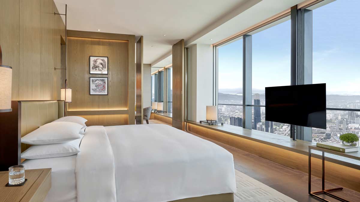 a bedroom with a large window and a television
