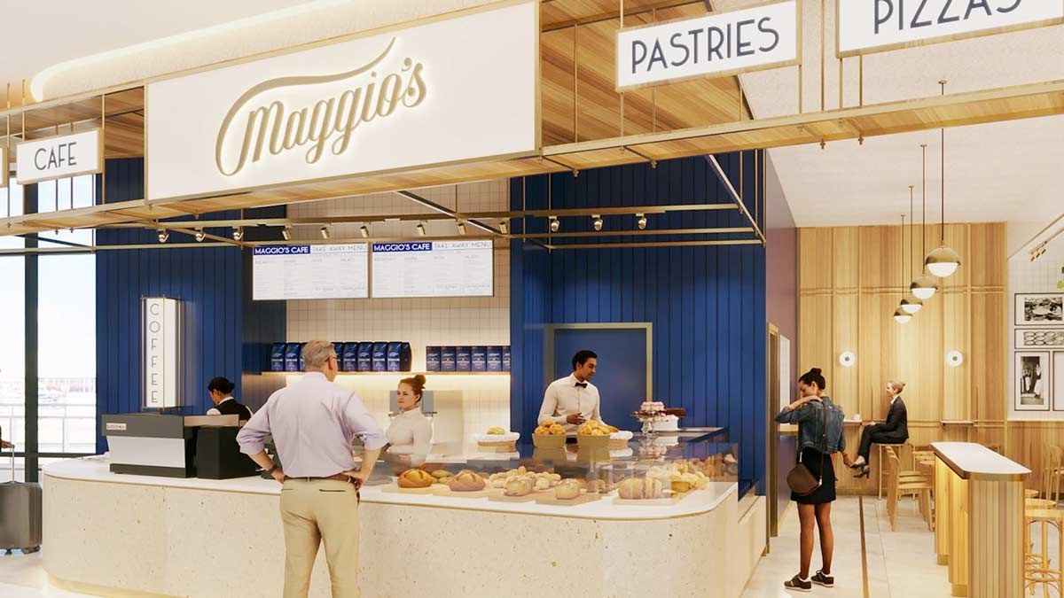 a group of people standing in front of a bakery